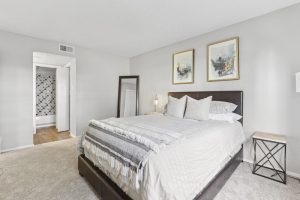 a bedroom with a white bed and carpeted floor at The 3001 Crystal Springs