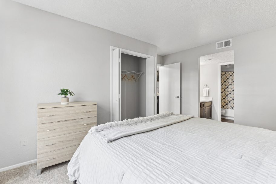a clean bedroom with white bedding and a dresser at The 3001 Crystal Springs